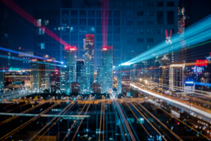 Light trails above buildings at night in China.